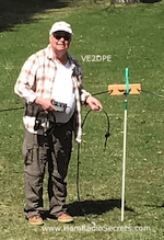Picture shows VE2DPE holding a KX2 transceiver just after having run some tests on his portable NVIS antenna for 40 m.